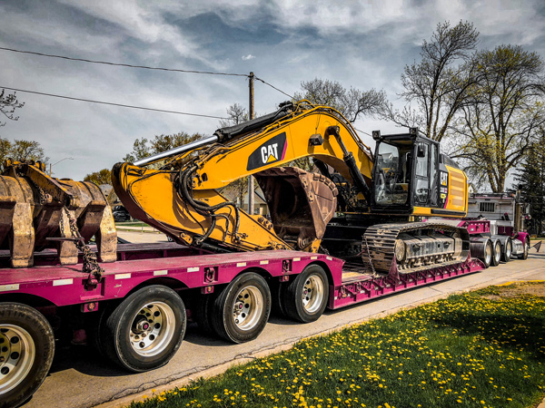 Flatbed truck with heavy machinery